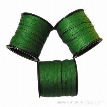 Paper raffia ribbon on plastic spool, various colors are available
